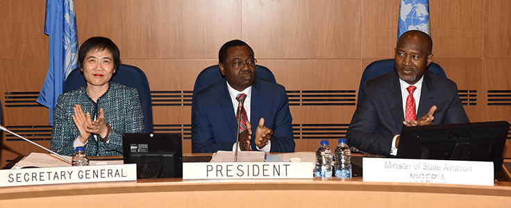 Dr. Olumuyiwa Benard Aliu of Nigeria (centre) is congratulated on his re-election as Council President by the Representatives of the ICAO Council. Seated with him on the occasion are ICAO Secretary General, Dr. Fang Liu (left,) and Nigeria's Minister of State Aviation, Hadi Sirika (right).